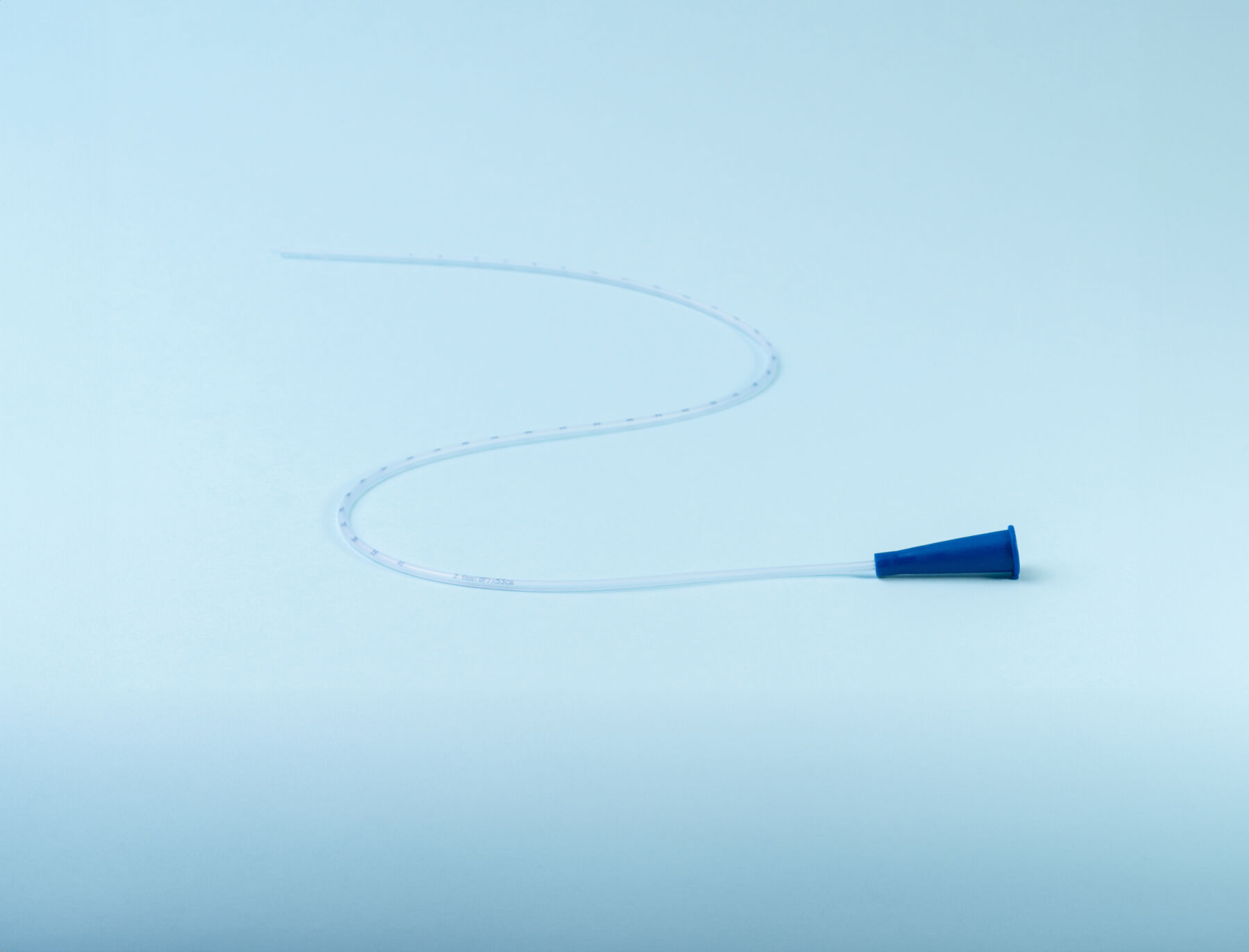 Rusch male and female all purpose catheter on blue background, straight tipped intermittent catheters designed for a single use