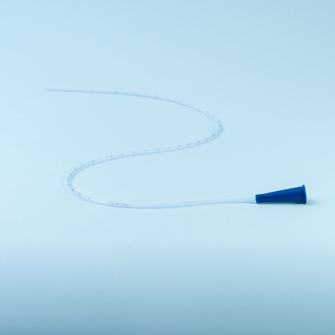 Rusch male and female all purpose catheter on blue background, straight tipped intermittent catheters designed for a single use