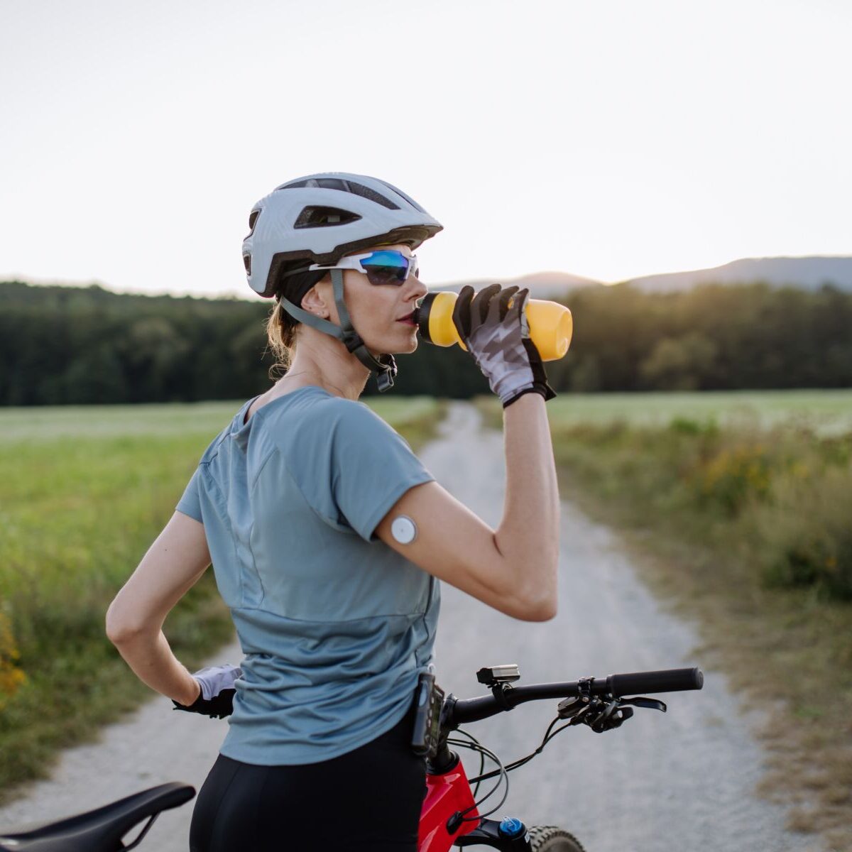 Diabetic,Cyclist,With,A,Continuous,Glucose,Monitor,On,Her,Arm